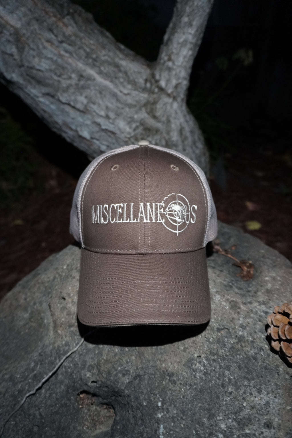 Brown trucker hat with khaki mesh back and white embroidered Miscellaneous logo
