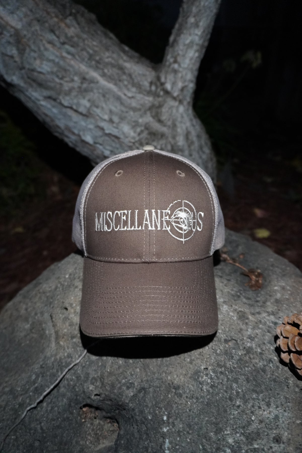 Brown trucker hat with khaki mesh back and white embroidered Miscellaneous logo