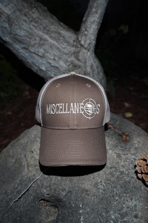 Brown trucker hat with khaki mesh back and white embroidered Miscellaneous logo
