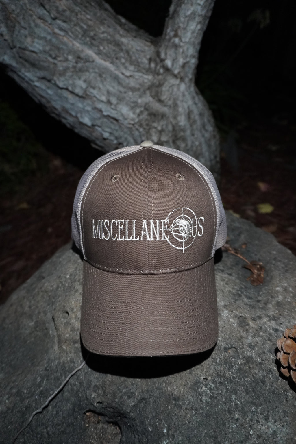 Brown trucker hat with khaki mesh back and white embroidered Miscellaneous logo