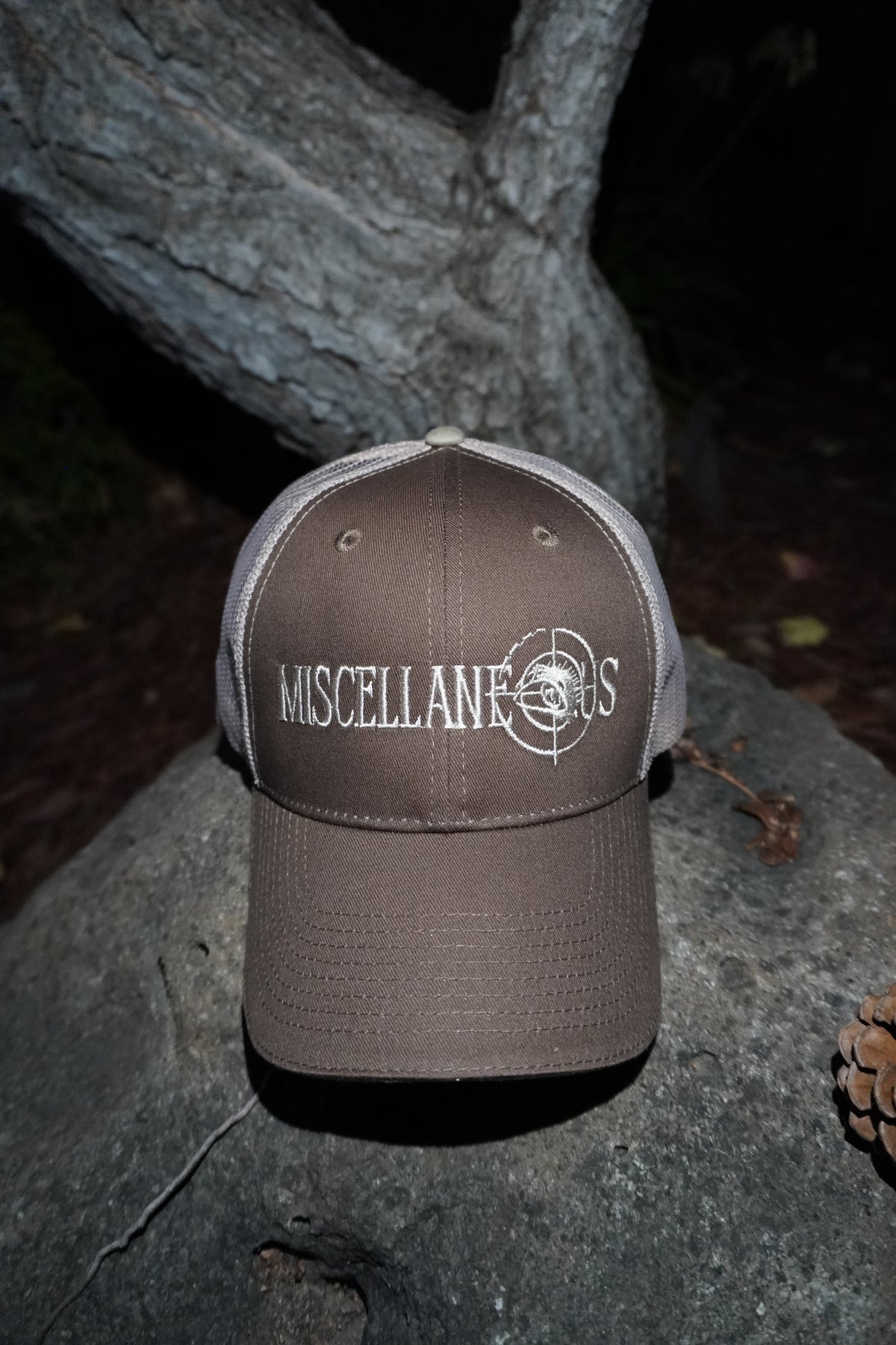 Brown trucker hat with khaki mesh back and white embroidered Miscellaneous logo