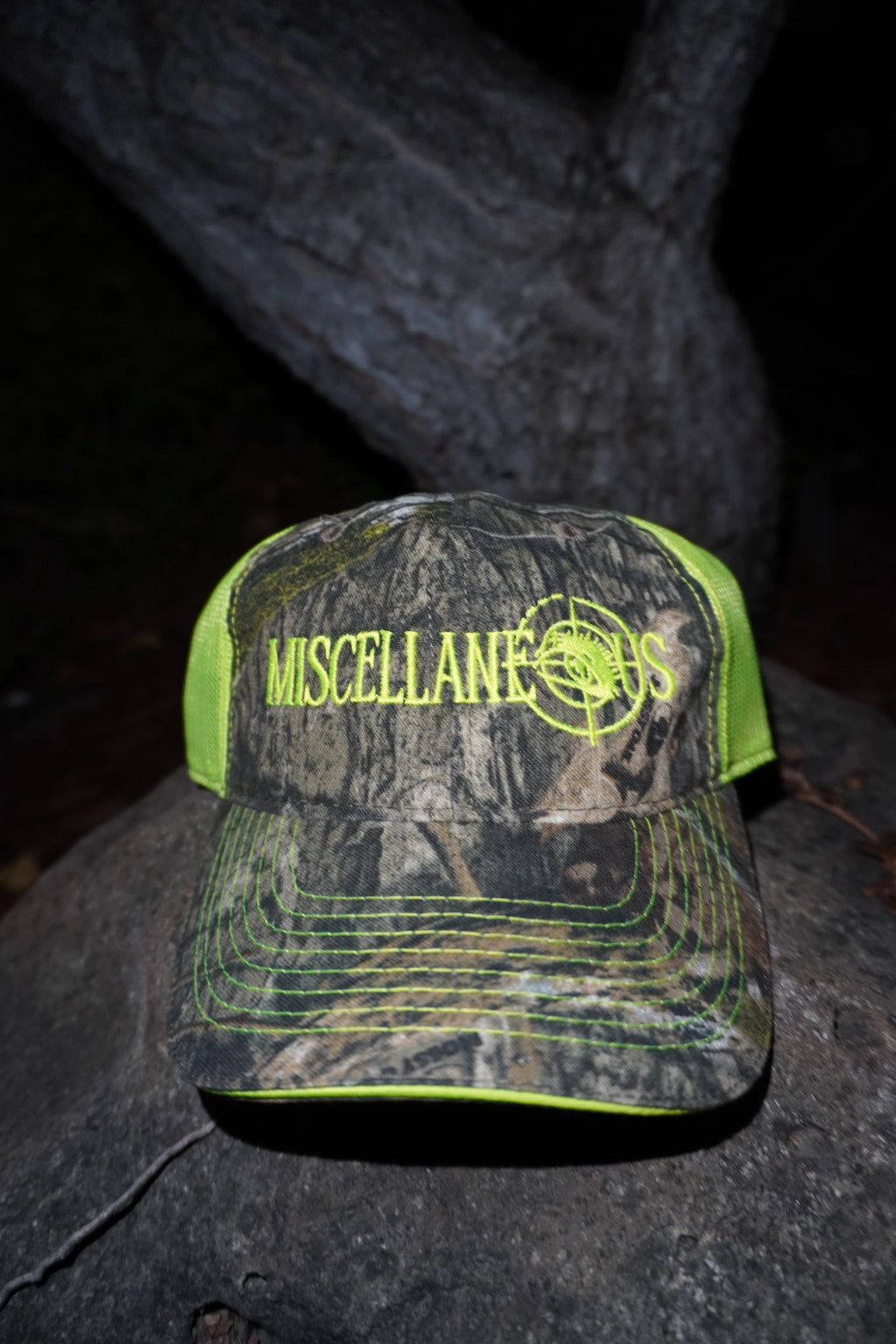 Realtree camo trucker hat with neon yellow mesh and neon yellow embroidered Miscellaneous logo