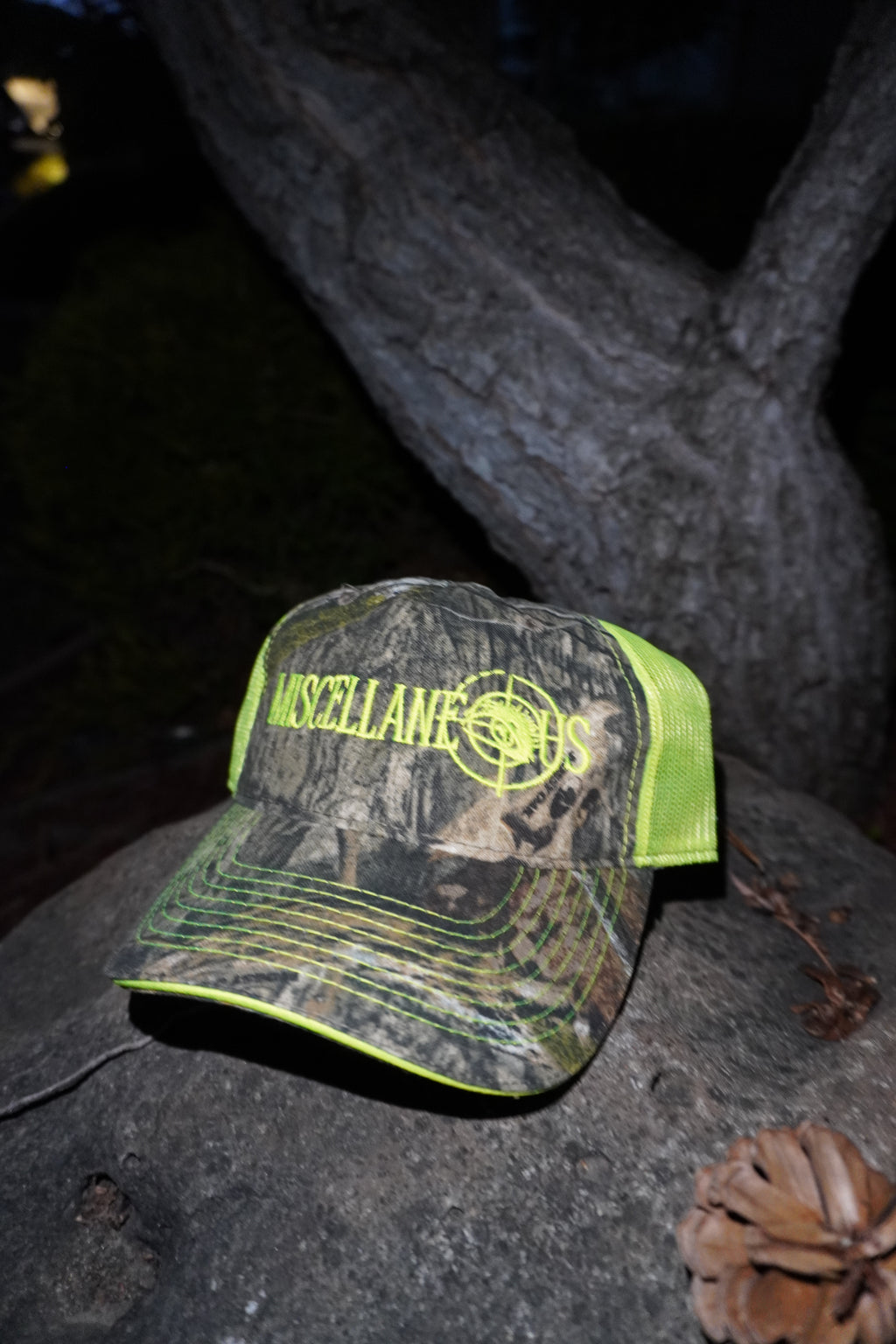 Realtree camo trucker hat with neon yellow mesh and neon yellow embroidered Miscellaneous logo