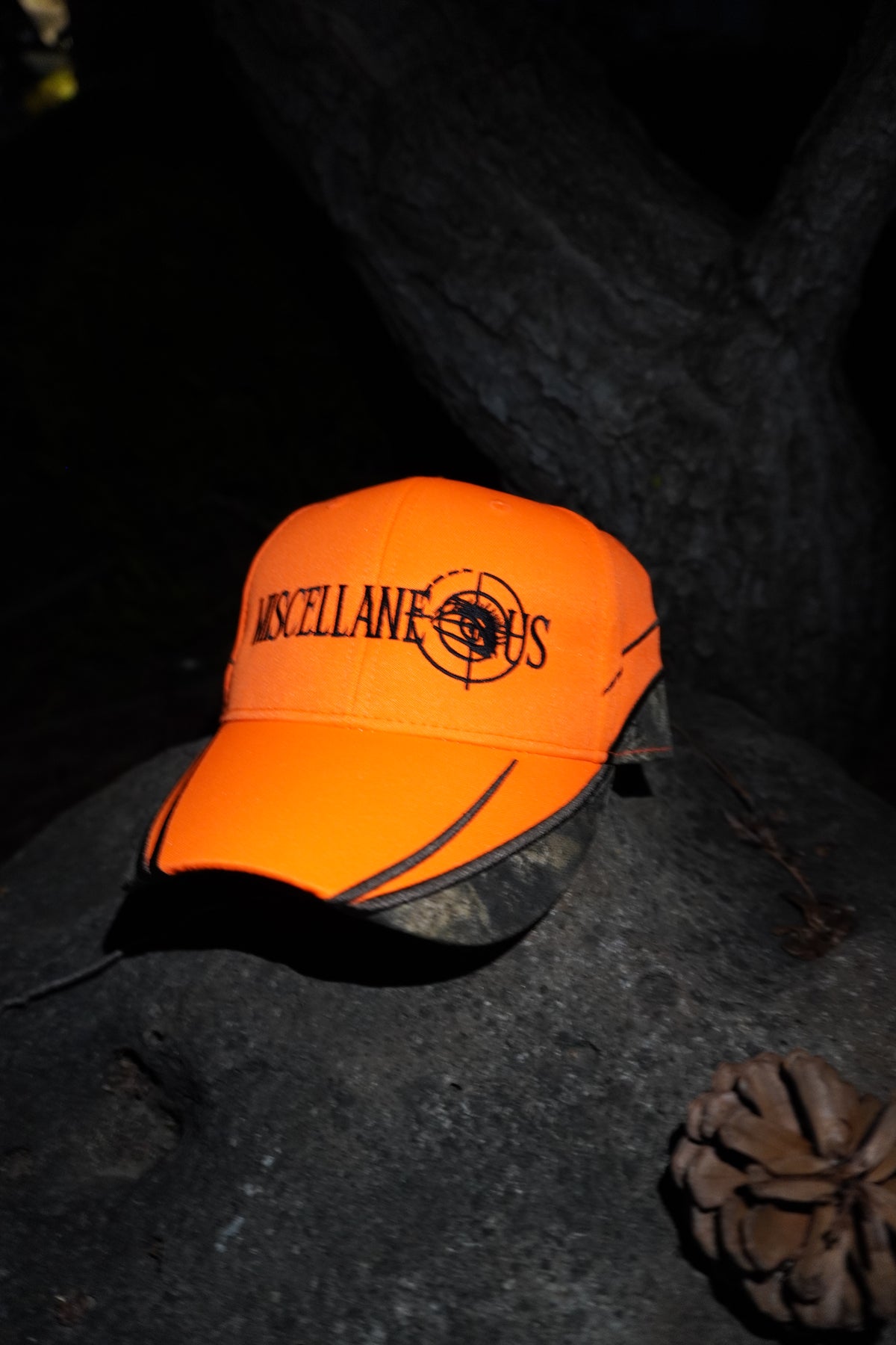 Blaze orange hat with Realtree camo trim and black embroidered Miscellaneous logo