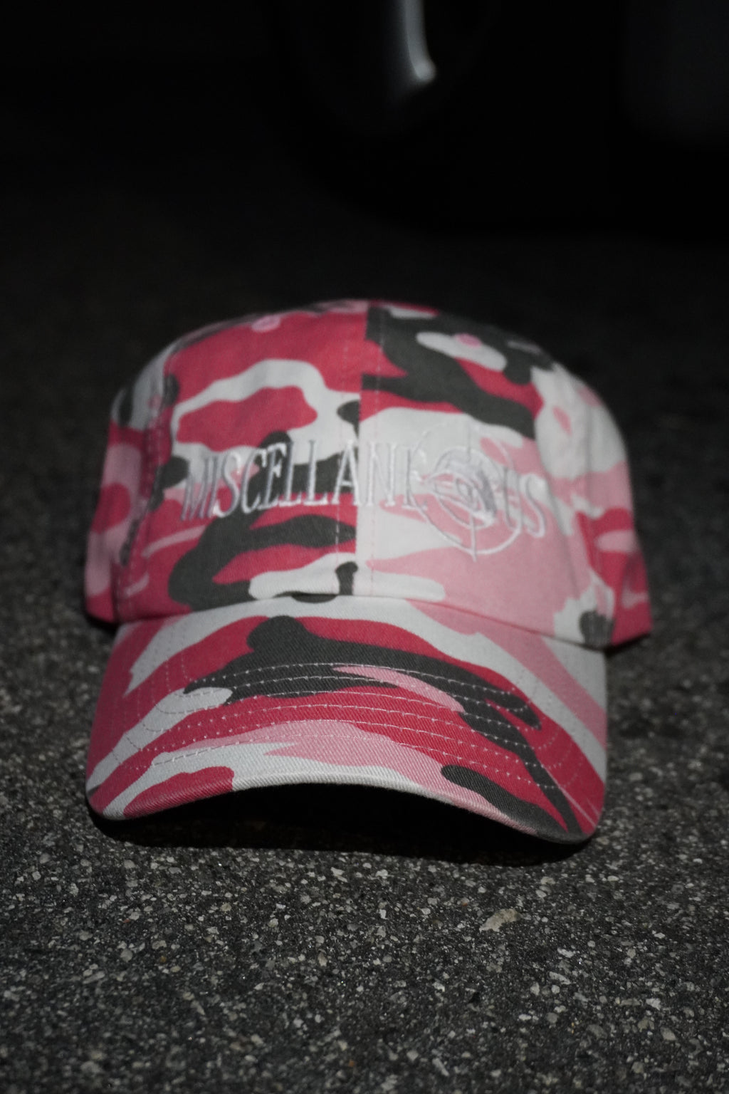 Pink camo dad hat with white embroidered Miscellaneous logo