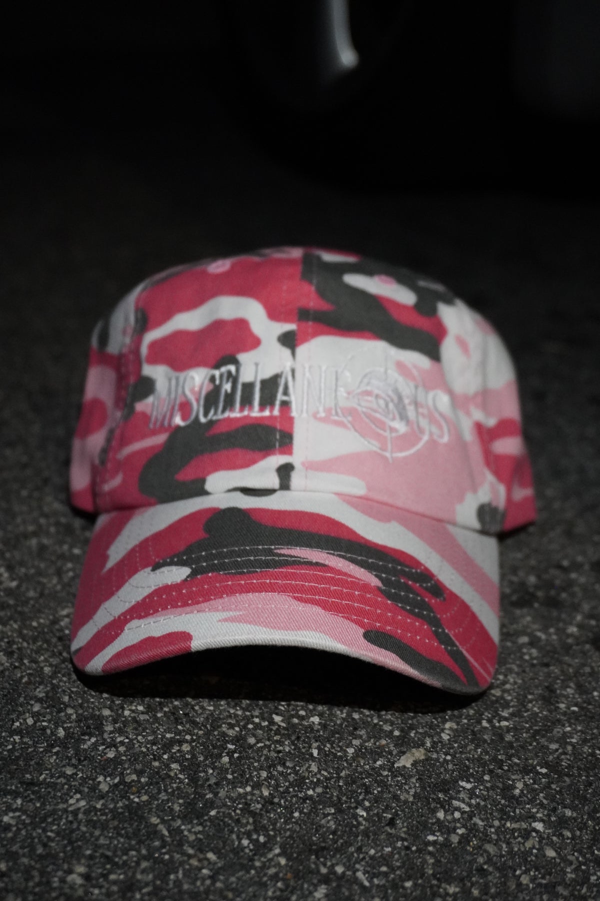 Pink camo dad hat with white embroidered Miscellaneous logo