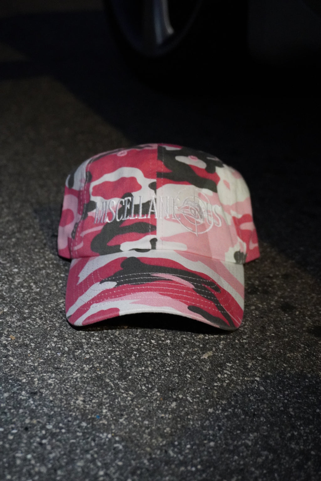 Pink camo dad hat with white embroidered Miscellaneous logo