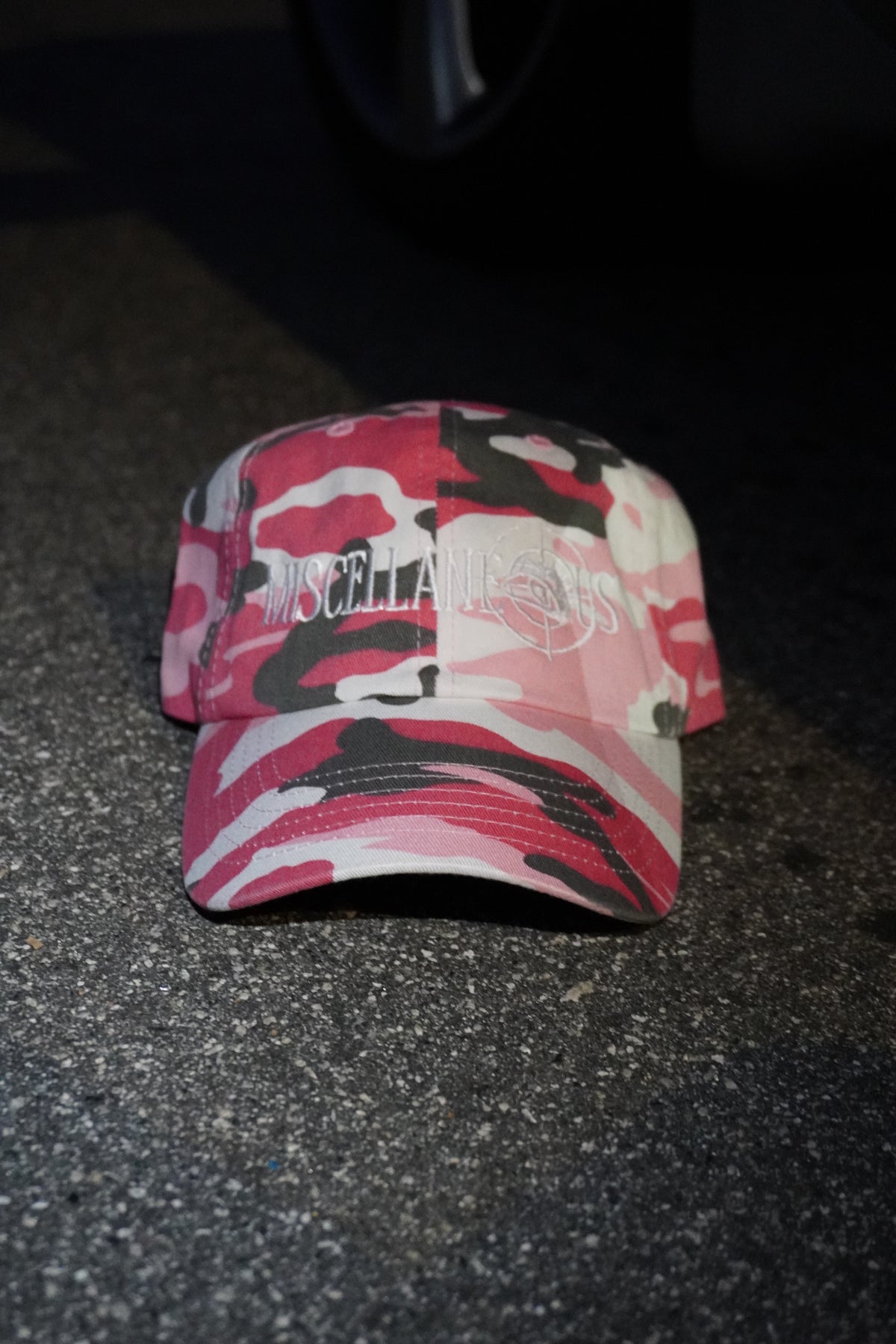 Pink camo dad hat with white embroidered Miscellaneous logo