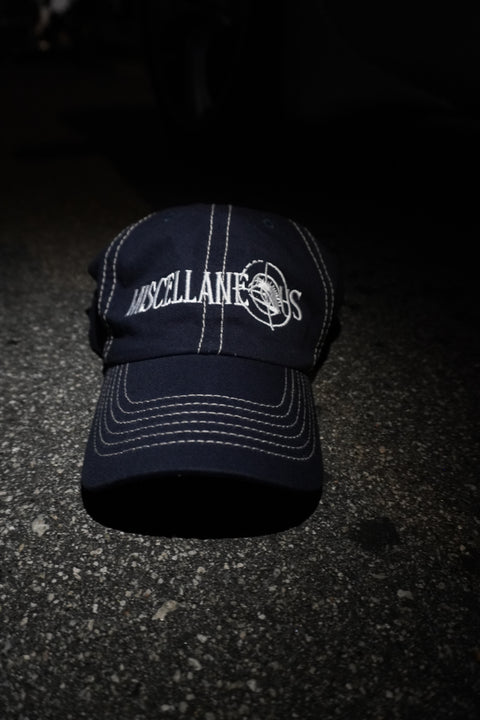 Navy dad hat with stone contrast stitching and white embroidered Miscellaneous logo