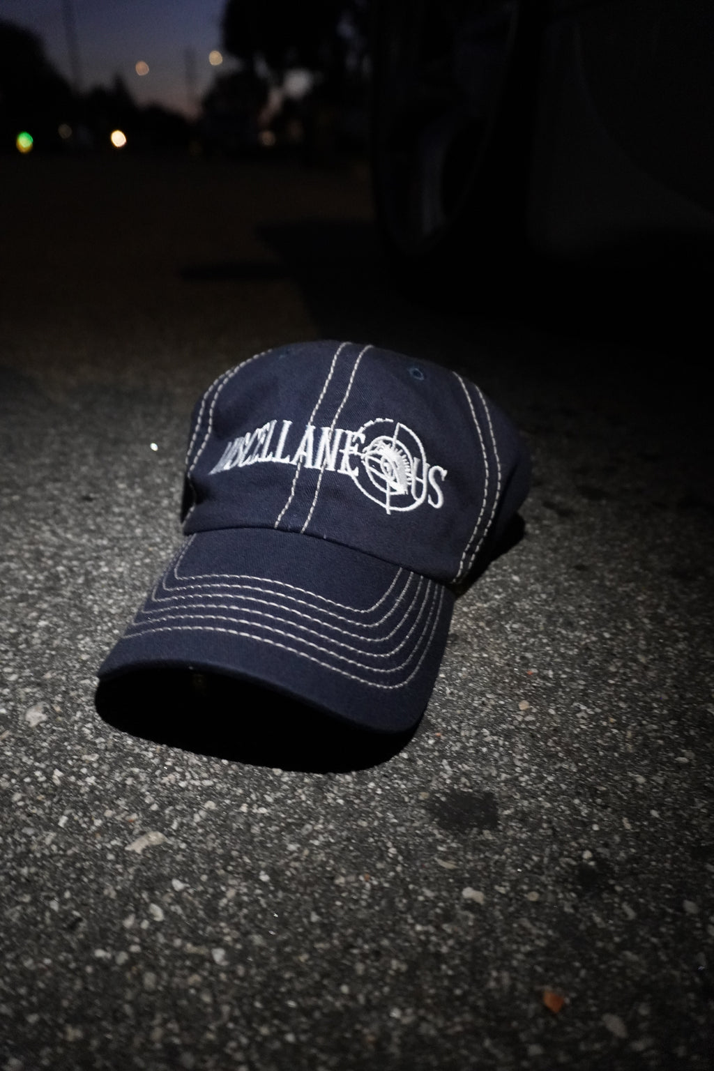 Navy dad hat with stone contrast stitching and white embroidered Miscellaneous logo