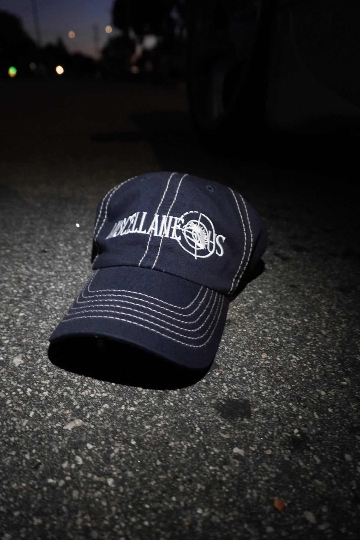 Navy dad hat with stone contrast stitching and white embroidered Miscellaneous logo