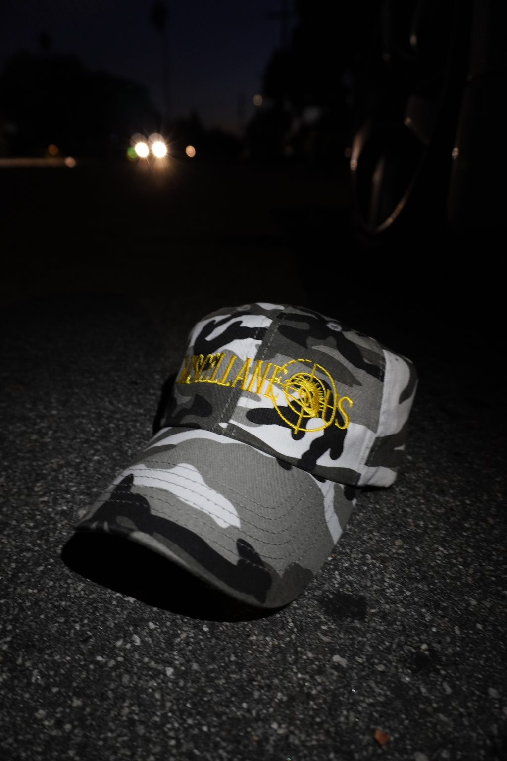 Gray camo dad hat with gold embroidered Miscellaneous logo